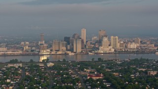 PVED01_015 - 4K aerial stock footage of Downtown New Orleans skyline seen from across the Mississippi River at sunrise, Louisiana