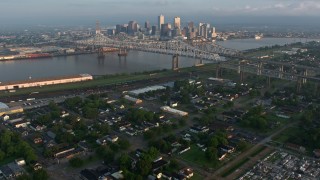 PVED01_017 - 4K aerial stock footage tilt from cemetery to reveal Crescent City Connection and Downtown at sunrise, Louisiana