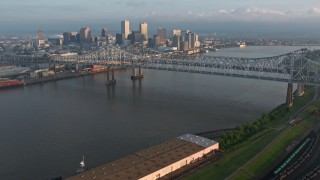 PVED01_018 - 4K aerial stock footage tilt to reveal Crescent City Connection and Downtown New Orleans at sunrise, Louisiana
