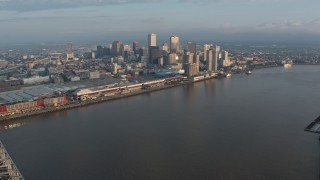 PVED01_020E - 4K aerial stock footage of the Crescent City Connection, reveal Downtown New Orleans at sunrise, Louisiana