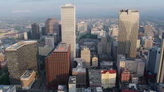 PVED01_024 - 4K aerial stock footage fly between One Shell Square and Place St. Charles in Downtown New Orleans at sunrise, Louisiana
