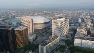PVED01_025 - 4K aerial stock footage of Downtown New Orleans and City Hall, approach the Superdome at sunrise, Louisiana