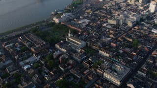 PVED01_033 - 4K aerial stock footage of St. Louis Cathedral and Jackson Square, French Quarter, reveal Downtown New Orleans, Louisiana, sunrise