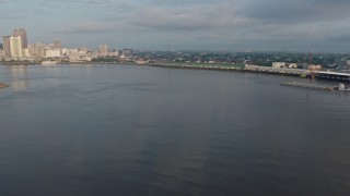 PVED01_038 - 4K aerial stock footage fly low over the Mississippi River toward French Quarter docks at sunrise, Louisiana