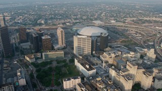 PVED01_041E - 4K aerial stock footage orbiting the Superdome in Downtown New Orleans, Louisiana at sunrise