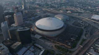 PVED01_042 - 4K aerial stock footage orbit of the Superdome and the New Orleans Arena in Downtown New Orleans at sunrise, Louisiana
