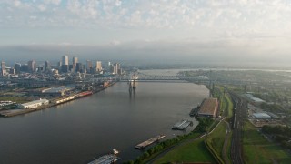 PVED01_044 - 4K aerial stock footage of Crescent City Connection Bridge at sunrise spanning the Mississippi River, New Orleans, Louisiana