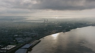 PVED01_050 - 4K aerial stock footage of Bywater and the Mississippi River in New Orleans at sunrise, Louisiana