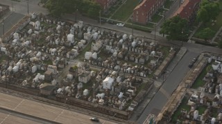 PVED01_054 - 4K aerial stock footage of two cemeteries in the French Quarter of New Orleans at sunrise, Louisiana