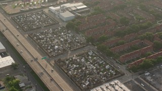 PVED01_055E - 4K aerial stock footage orbit three cemeteries in the French Quarter at sunrise, New Orleans, Louisiana