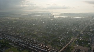 PVED01_058E - 4K aerial stock footage fly over Upper Ninth Ward toward factory by the Canal at sunrise, New Orleans, Louisiana