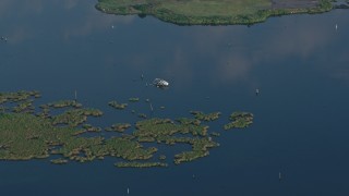 PVED01_066E - 4K aerial stock footage orbit a capsized boat in the water at sunrise in St. Bernard Parish, Louisiana