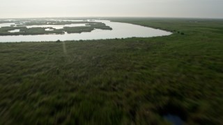 PVED01_071 - 4K aerial stock footage tilt and fly low over marshland and bayou in St. Bernard Parish, Louisiana at sunrise