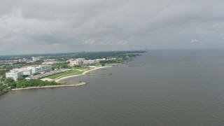 PVED01_092E - 4K aerial stock footage orbit apartment buildings and suburbs by canal near shore of Lake Pontchartrain in Gentilly, Louisiana
