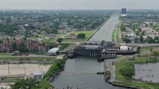 PVED01_100 - 4K aerial stock footage approach and fly over 17th Street Canal pumping station in Metairie, New Orleans, Louisiana
