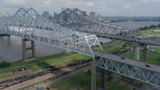PVED01_113 - 4K aerial stock footage flyby Crescent City Connection Bridge and reveal Downtown New Orleans skyline, Louisiana