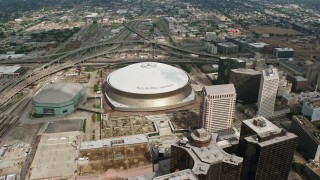 PVED01_124E - 4K aerial stock footage wide orbit of the Superdome, New Orleans Arena and Downtown New Orleans skyscrapers, Louisiana
