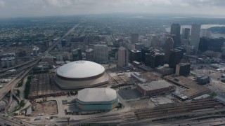 PVED01_125 - 4K aerial stock footage wide orbit of the Superdome, New Orleans Arena and Downtown New Orleans skyscrapers, Louisiana
