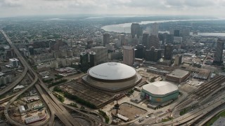 PVED01_126E - 4K aerial stock footage fly over Superdome and Downtown New Orleans to the Mississippi River, Louisiana