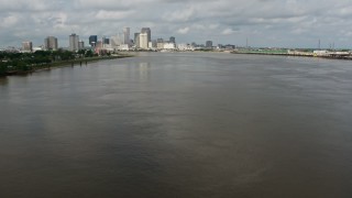 PVED01_128 - 4K aerial stock footage fly low over Mississippi River to approach Downtown New Orleans skyline, Louisiana