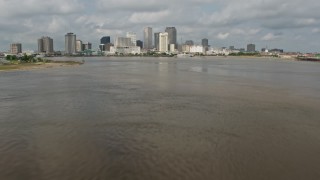 PVED01_129 - 4K aerial stock footage tilt to reveal Downtown New Orleans skyline while flying over Mississippi River, Louisiana