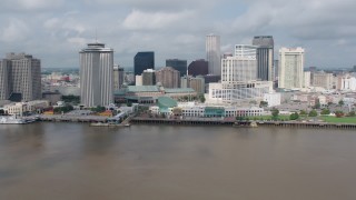 PVED01_130 - 4K aerial stock footage tilt to reveal Downtown New Orleans riverfront skyscrapers, Louisiana