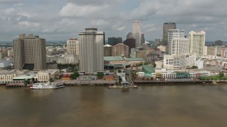 PVED01_130E - 4K aerial stock footage tilt to reveal Downtown New Orleans riverfront skyscrapers and Cruise Ship, Louisiana