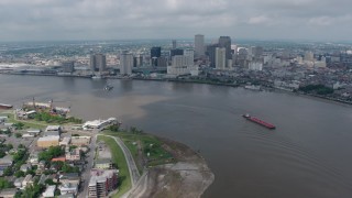 PVED01_143 - 4K stock footage aerial video fly over Mississippi River to approach Downtown New Orleans, Louisiana