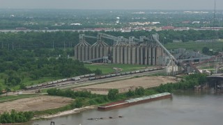 PVED01_151 - 4K aerial stock footage factory silos on the shore of the Mississippi River in New Orleans, Louisiana