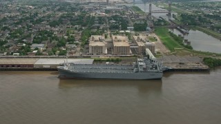 PVED01_161 - 4K aerial stock footage orbit two Naval Reserve warships docked on the Mississippi River in Bywater, New Orleans, Louisiana