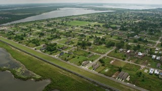 PVED01_165E - 4K aerial stock footage urban neighborhood and canal in Lower Ninth Ward, tilt to reveal industrial area on Industrial Canal, Louisiana
