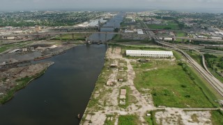 PVED01_167 - 4K aerial stock footage approach small bridges and factory in New Orleans East, Louisiana