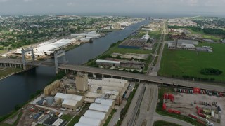 PVED01_168 - 4K aerial stock footage flyby small bridge and factory buildings on the shore of Industrial Canal in New Orleans East, Louisiana