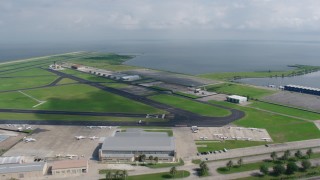 PVED01_170 - 4K aerial stock footage fly over New Orleans Lakefront Airport to approach Lake Pontchartrain, Louisiana
