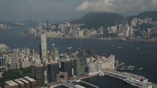 SS01_0008 - 5K stock footage aerial video of Kowloon waterfront office buildings and Victoria Harbor in Hong Kong, China
