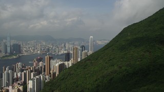 SS01_0039 - 5K stock footage aerial video approach skyscrapers on Hong Kong Island from green mountains, China