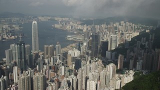 SS01_0041 - 5K stock footage aerial video approach and pan across Hong Kong Island skyscrapers seen from green mountains, China