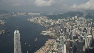 SS01_0043 - 5K stock footage aerial video of waterfront skyscrapers and convention center along Victoria Harbor on Hong Kong Island, China