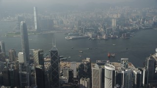 SS01_0083 - 5K stock footage aerial video approach harbor from Hong Kong Island and pan across the water and Kowloon shoreline, China