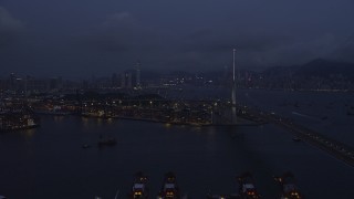 SS01_0116 - 5K stock footage aerial video of flying by Stonecutters Bridge to approach part of the Port of Hong Kong at night in China