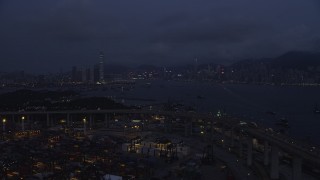 SS01_0119 - 5K stock footage aerial video fly over Port of Hong Kong to approach Kowloon and Hong Kong Island at night, China