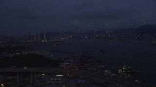 SS01_0120 - 5K stock footage aerial video approach Kowloon and Hong Kong Island skylines from the Port of Hong Kong at night, China