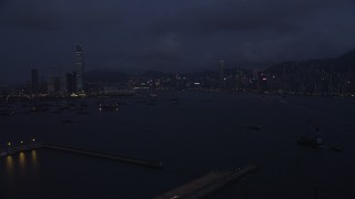 SS01_0122 - 5K stock footage aerial video of approaching the Kowloon and Hong Kong Island skylines at night in China