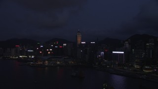 SS01_0132 - 5K stock footage aerial video approach Hong Kong Island skyscrapers and convention center at night, China