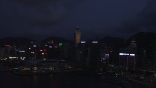 SS01_0133 - 5K stock footage aerial video approach skyscrapers and convention center on Hong Kong Island at night, China