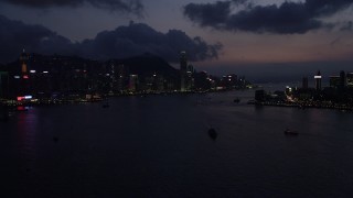 SS01_0139 - 5K stock footage aerial video of Hong Kong Island skyline and Victoria Harbor at night, China