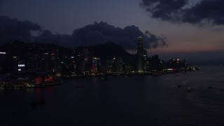 SS01_0142 - 5K stock footage aerial video waterfront skyline of Hong Kong Island and Victoria Harbor at night, China