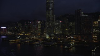 SS01_0148 - 5K stock footage aerial video approach piers on Hong Kong Island near skyscrapers at night in China