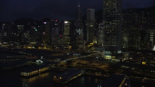 SS01_0149 - 5K stock footage aerial video flyby piers and skyscrapers on Hong Kong Island at night, China
