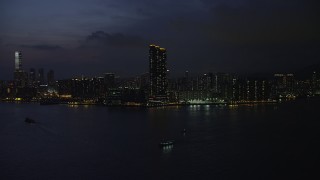 SS01_0156 - 5K stock footage aerial video approach Harbourfront Landmark skyscrapers in Kowloon, Hong Kong at night, China